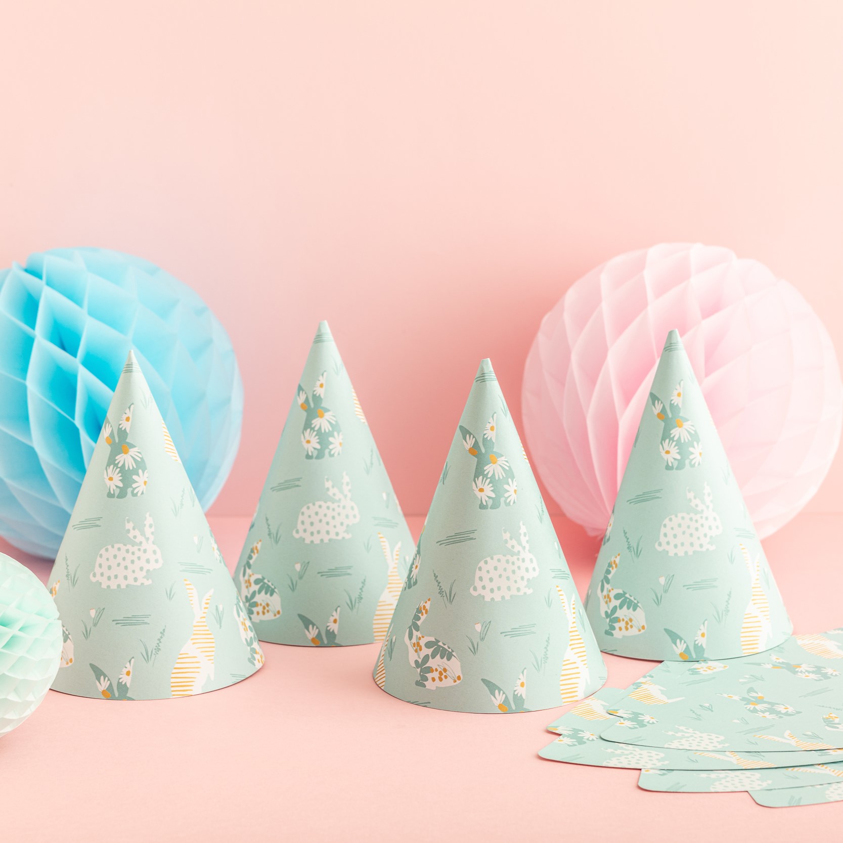 blue floral bunny rabbit party hats on a pink background